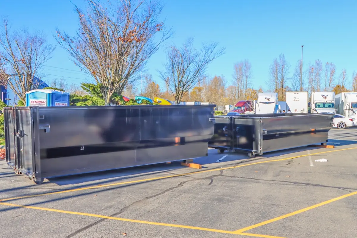 Professional dumpster rental service with roll-off container on residential driveway in Thornapple